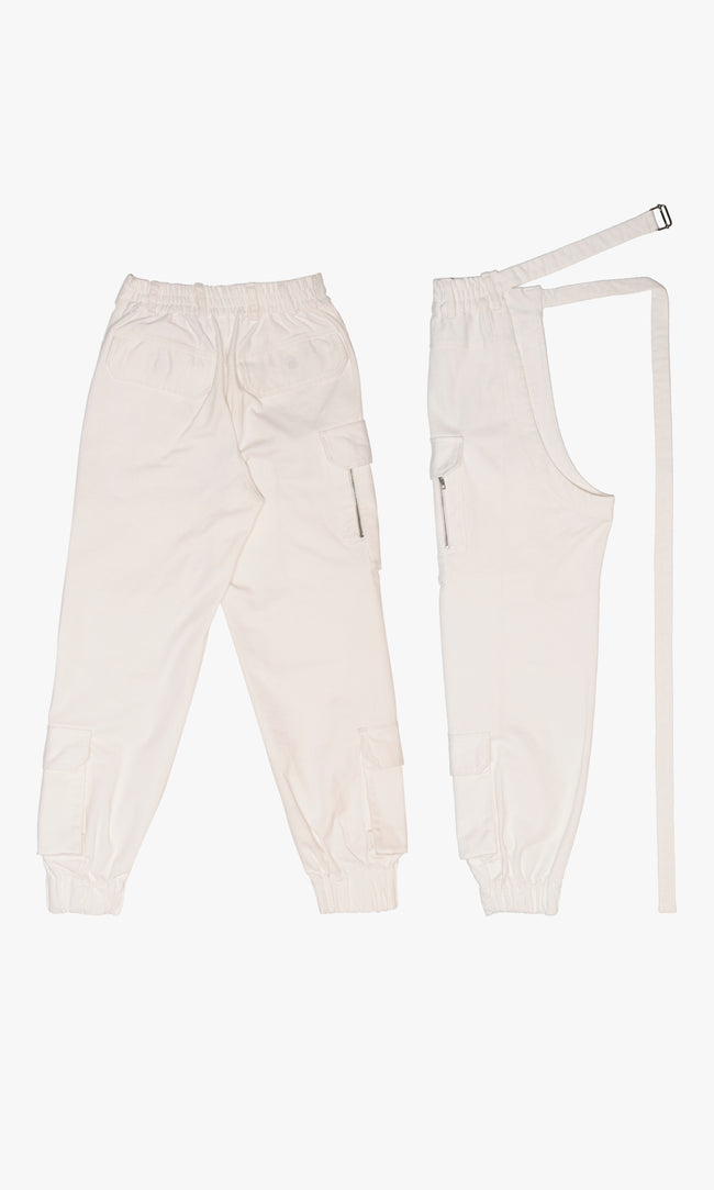 SIEGENTHALER |Back view of the modular cargo pants in off-white cotton twill. Features a zip-detachable left leg transforming into a single-leg apron silhouette, elastic cuffs, oversized patch pockets, and integrated belt strap. Designed for hybrid wearability and layered reinterpretation.