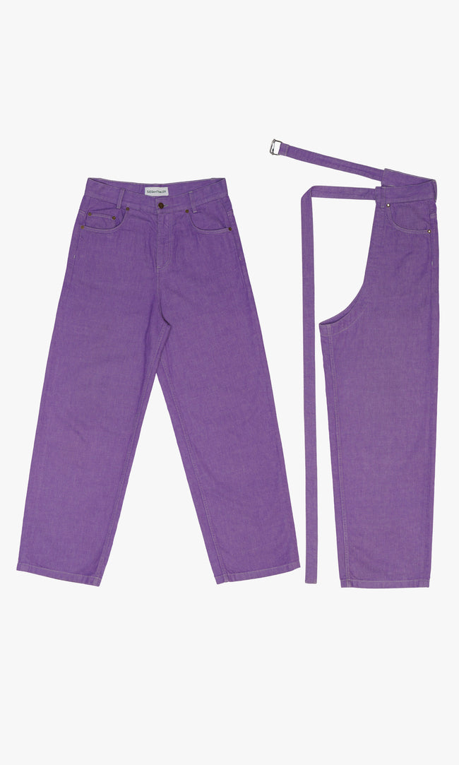 SIEGENTHALER | Front view of the purple denim jeans with detachable chaps. Highlighting sharp tailored paneling and modular belt extension, the design merges casual denim identity with utilitarian detailing.