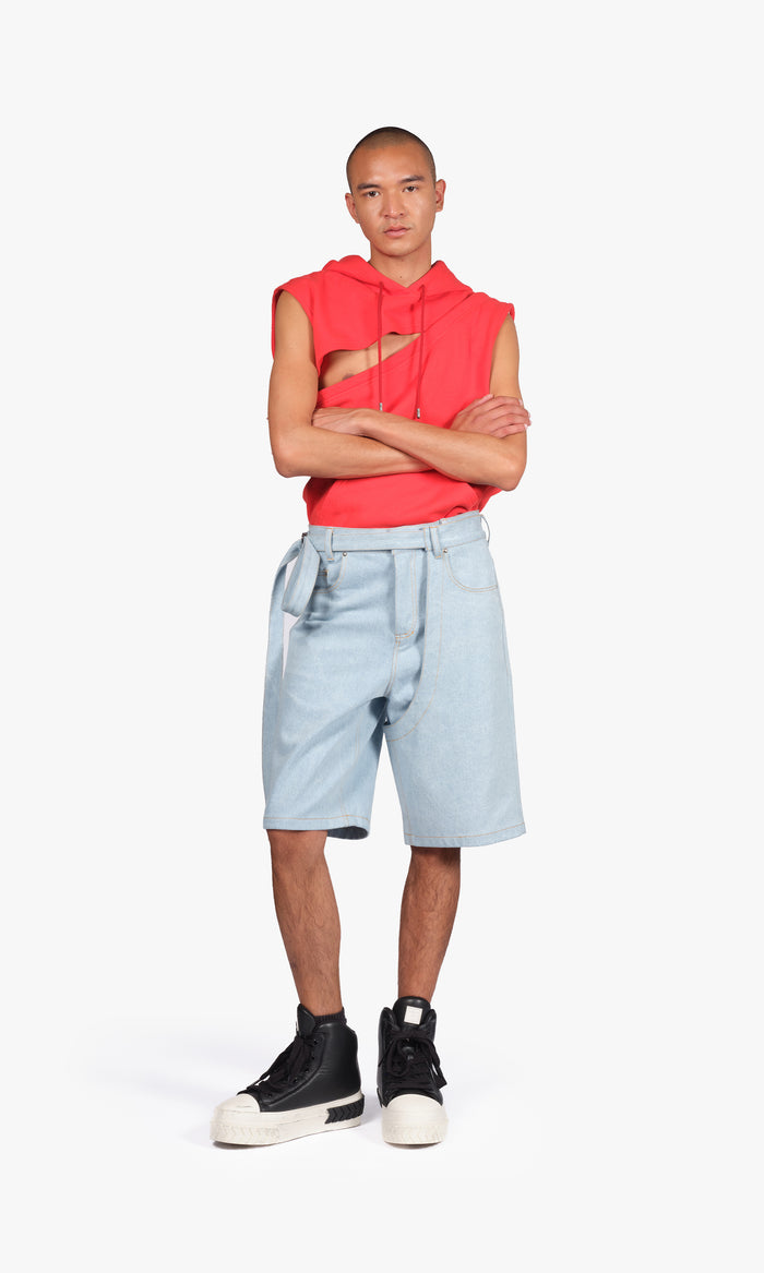 SIEGENTHALER | Full frontal view of the light denim shorts with distinctive curved paneling, oversized fit, and self-fabric belt. A utilitarian silhouette reimagined with architectural seams and precise topstitching.