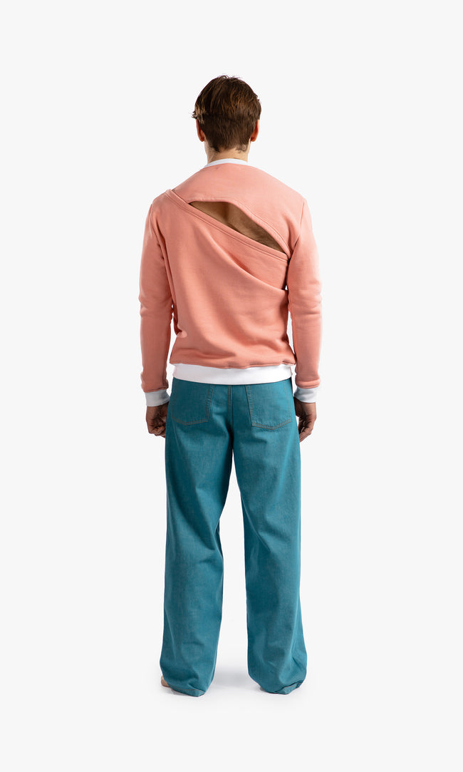 SIEGENTHALER | Back view of the unisex asymmetrical sweatshirt in rose tan, displaying the seamless construction and harness detail in white ribbing.