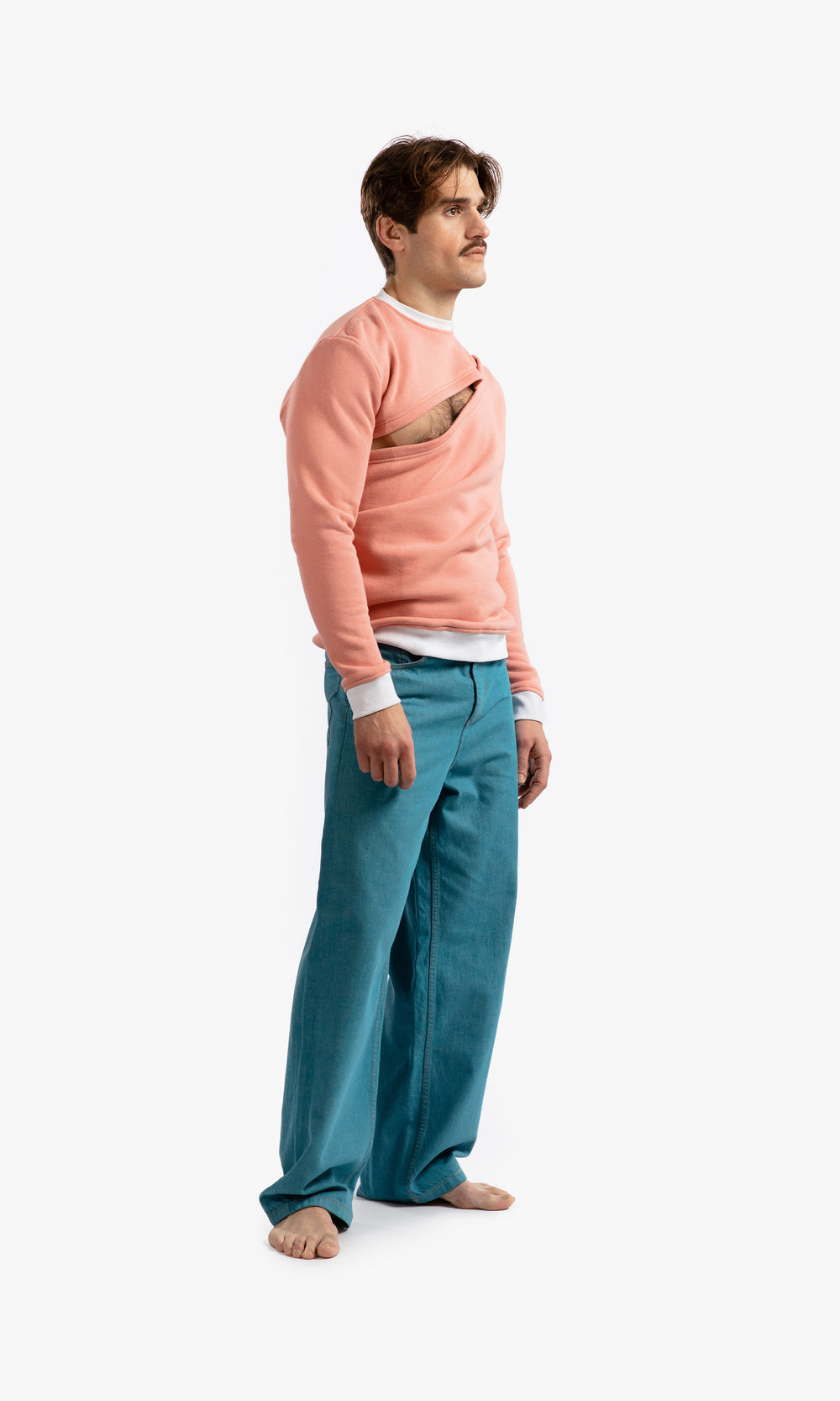 SIEGENTHALER | Side view of the unisex asymmetrical sweatshirt in rose tan, highlighting the detachable shoulder and underarm with invisible snap closures.