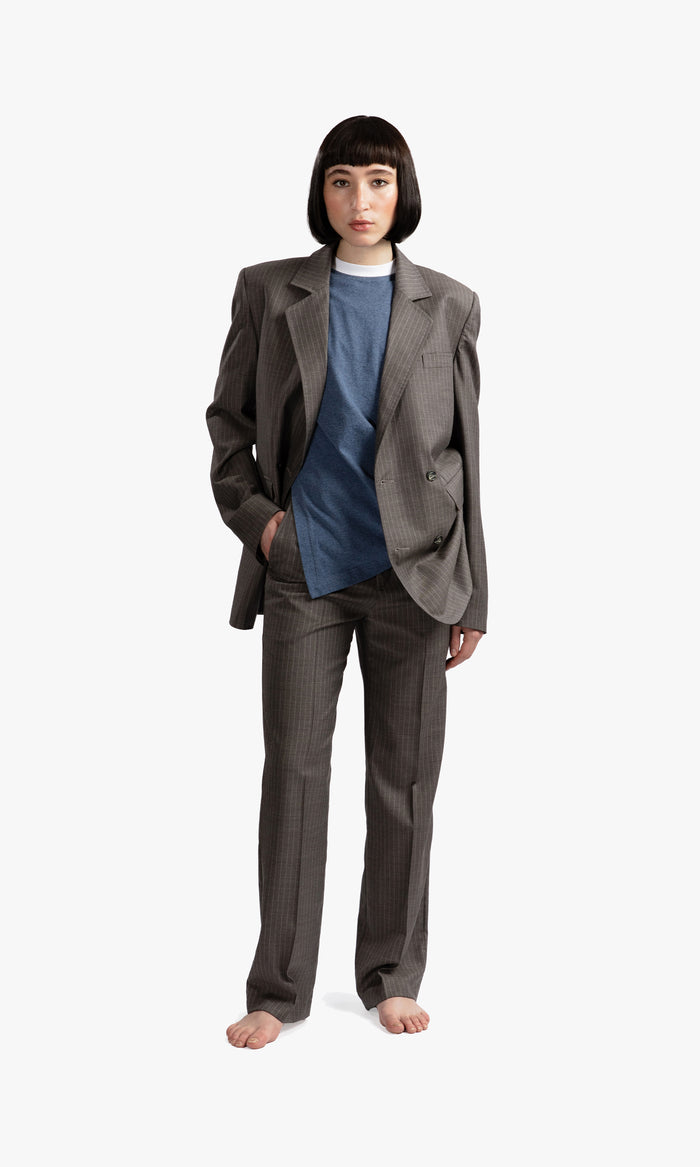 SIEGENTHALER | Front view of the unisex double-breasted suit jacket in grey pinstripe wool, showcasing its straight fit and notched lapel.