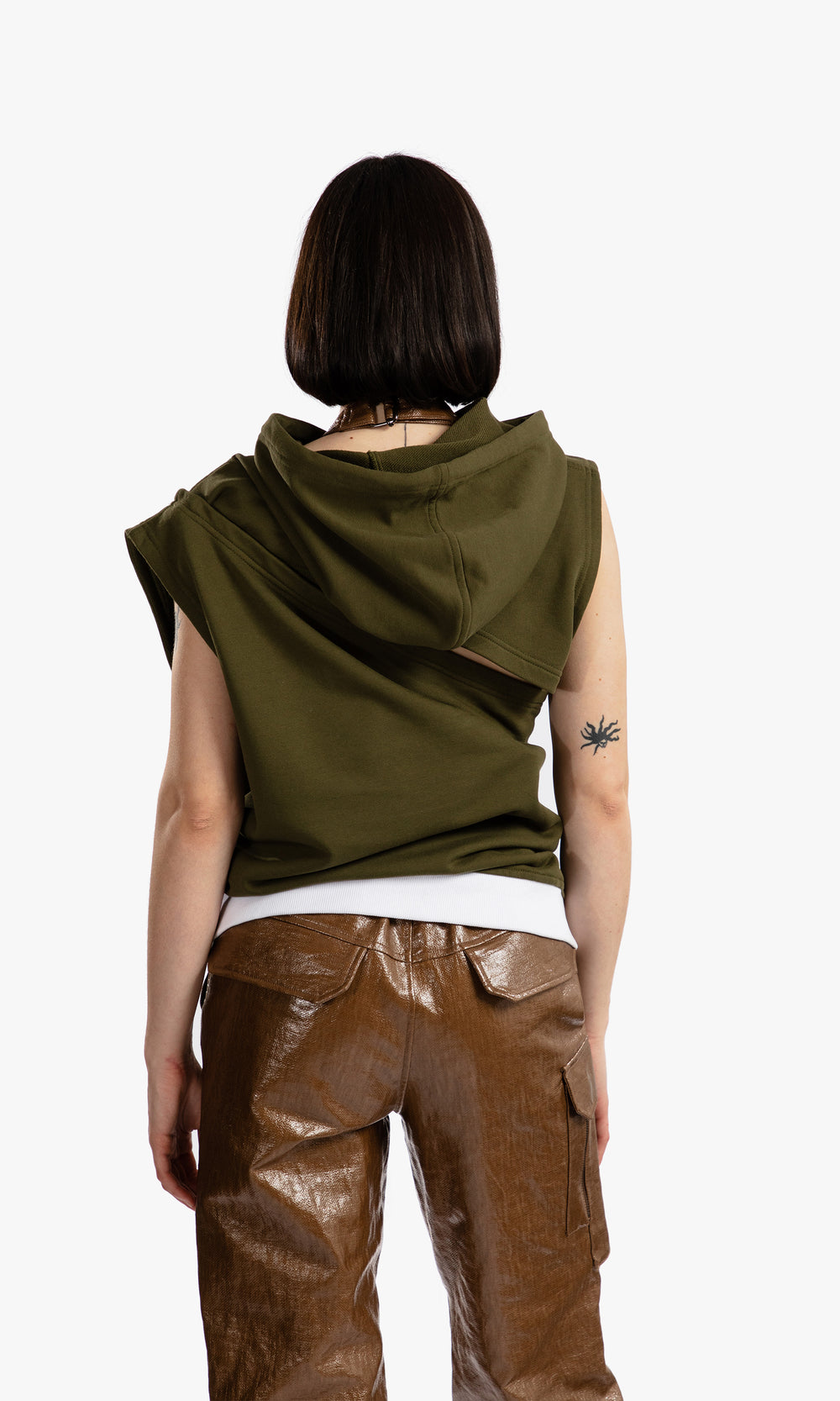 SIEGENTHALER | Back view of the HILDEGARD Hoodie worn. The draped, asymmetrical hood and diagonal wrap detail extend across the shoulder blades, creating a twisted, sculptural silhouette in soft khaki fleece.