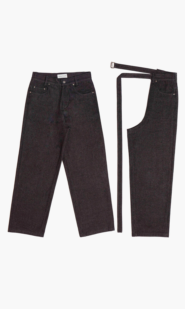  SIEGENTHALER | Dark denim jeans paired with detachable modular chaps. Classic five-pocket cut on the base layer. The overlaid chap leg attaches via a long matching belt, allowing for asymmetric styling or full transformation. Designed to be worn layered or independently.



