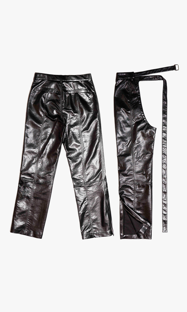  SIEGENTHALER | Faux leather pants with clean back welt pockets and full-length stitched panels. Includes matching detachable chaps with open back curve and long belt extension. A layered construction that plays on proportion and functionality.