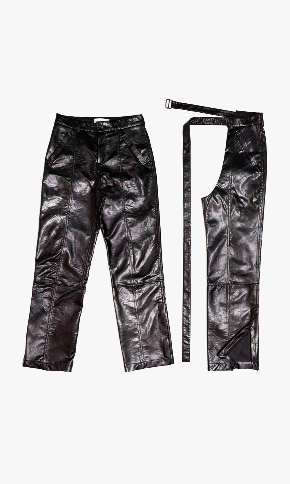  SIEGENTHALER | Straight-leg trousers in high-shine black faux leather with tailored panel lines. Comes with detachable wrap-around chaps featuring curved openings and extended straps at the waist. Designed for modular styling and bold contrasts in silhouette.

