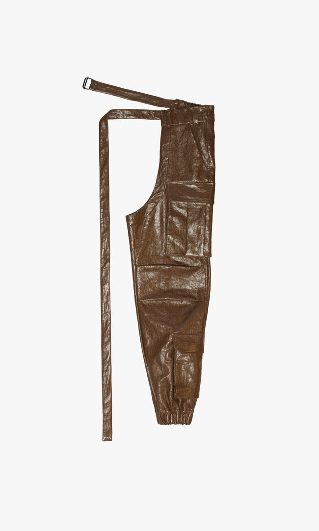 SIEGENTHALER | Front view of the unisex high-waisted cargo chap in rubber brown coated linen canvas, showcasing its relaxed fit and multiple utility pockets.