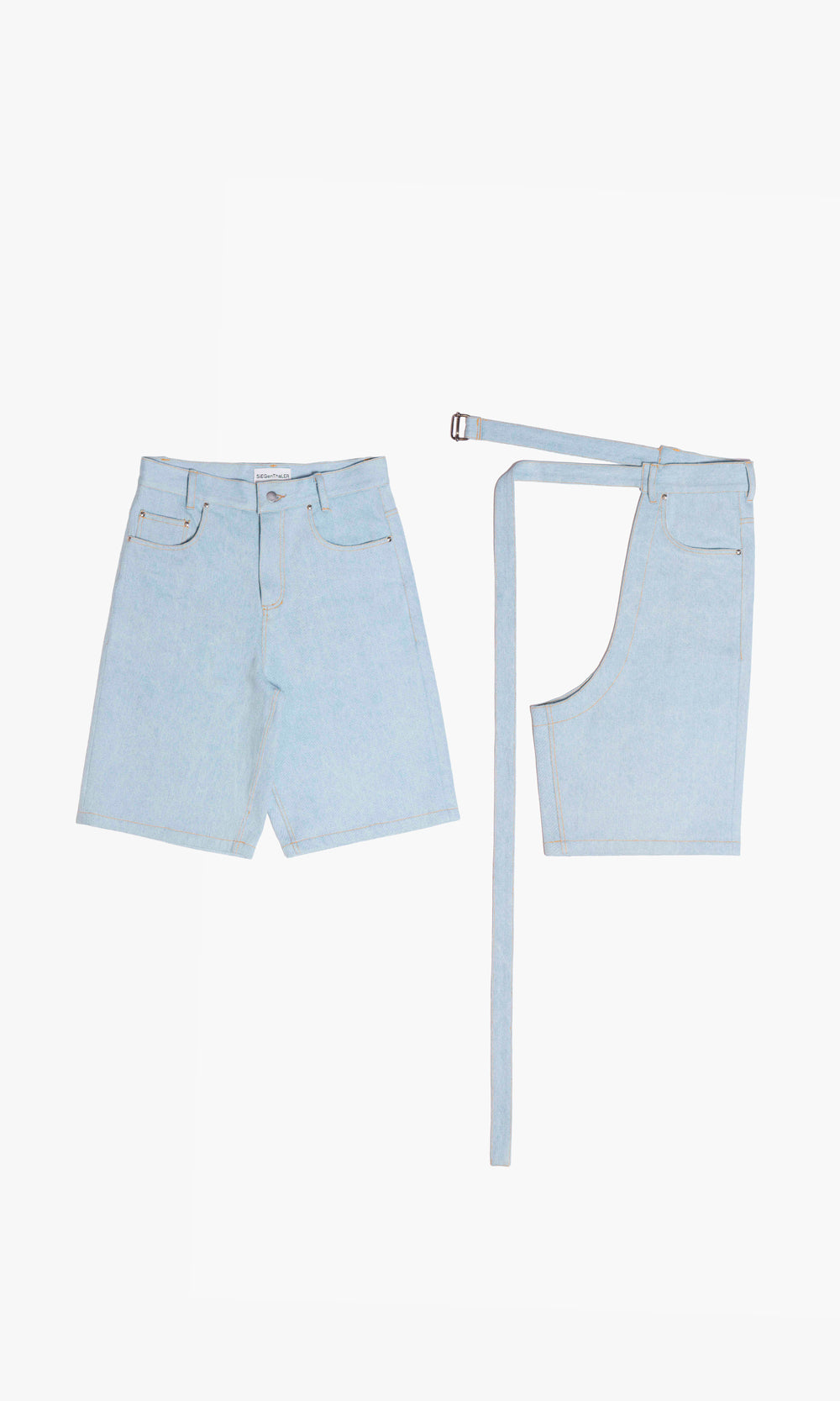 SIEGENTHALER | Modular denim shorts in light blue with integrated detachable chaps. Asymmetric waistband with belt closure and signature curved yoke. Designed for styling versatility and experimental layering.