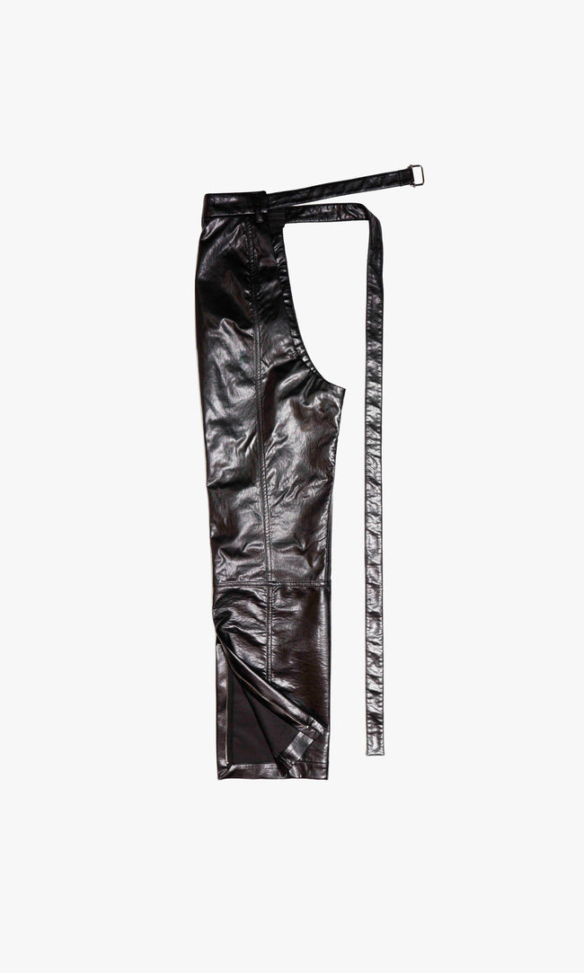  SIEGENTHALER | Back view of the CHAPP3 faux leather chaps reveals directional seamwork and tailored curvature for movement. Integrated belt strap allows custom closure and secure layering, showcasing the modular philosophy of the design.